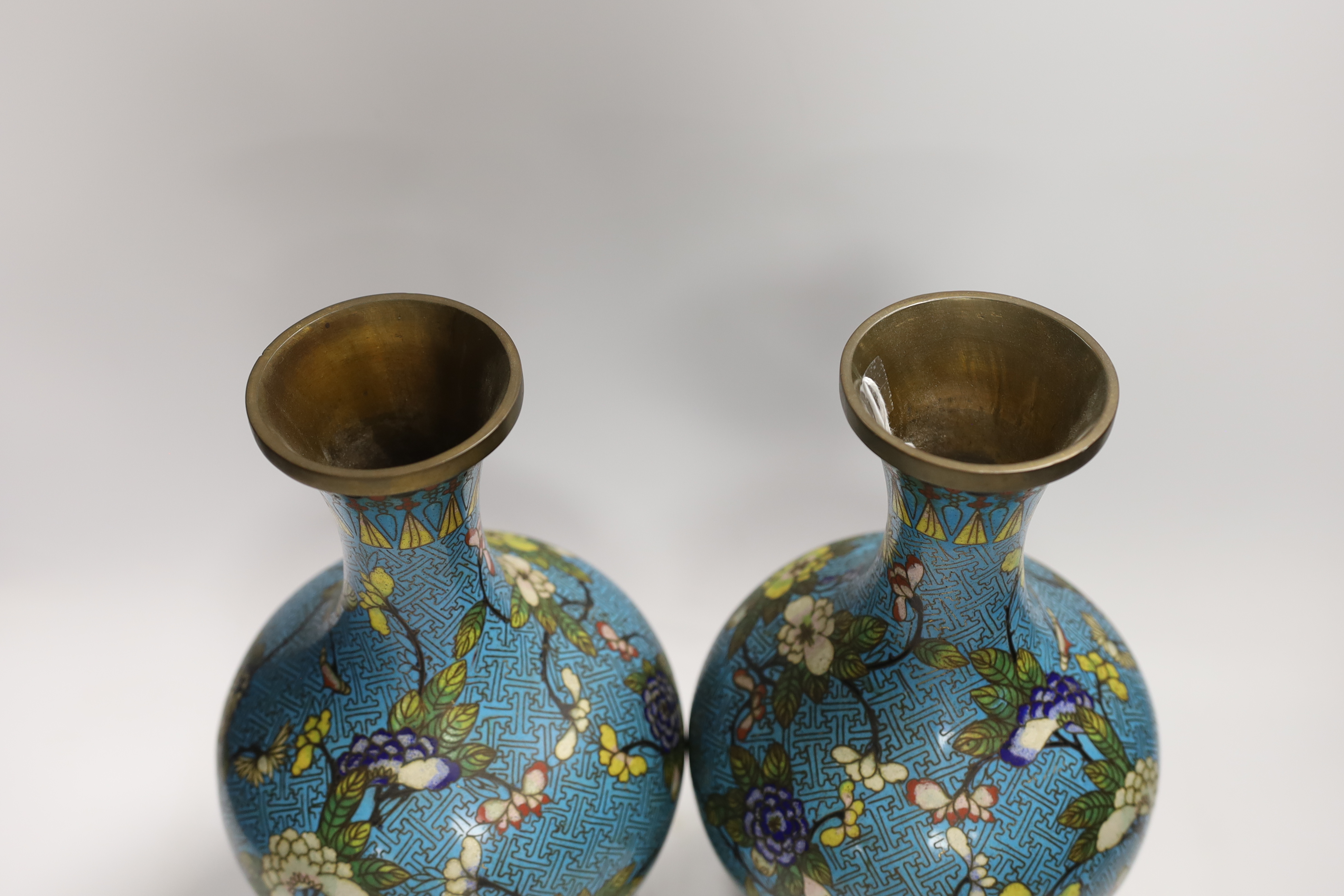 A pair of Chinese cloisonné enamel vases, late Qing dynasty, 31cm, (a.f.), on hardwood stands